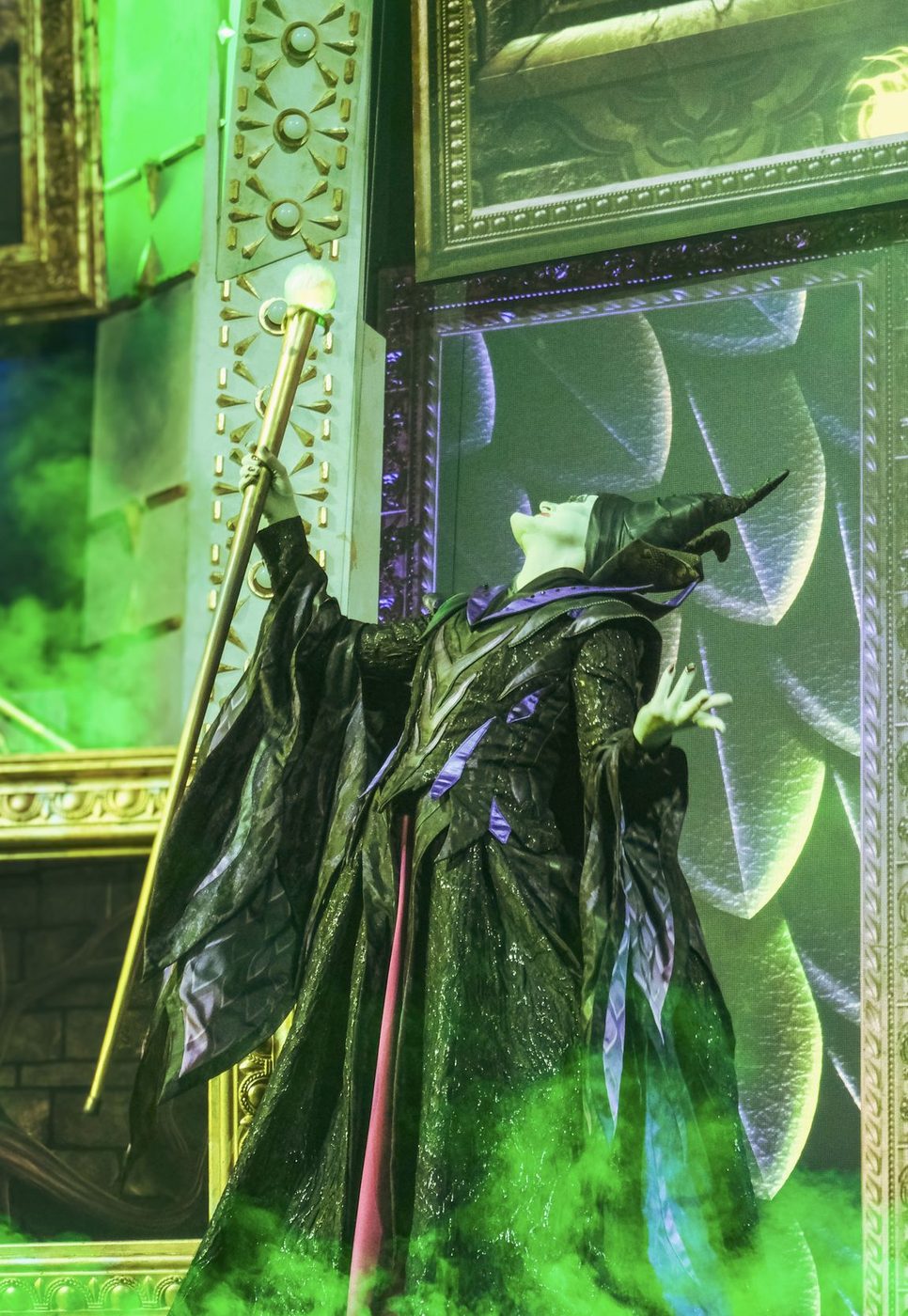 Maleficent raises her staff in the villains show