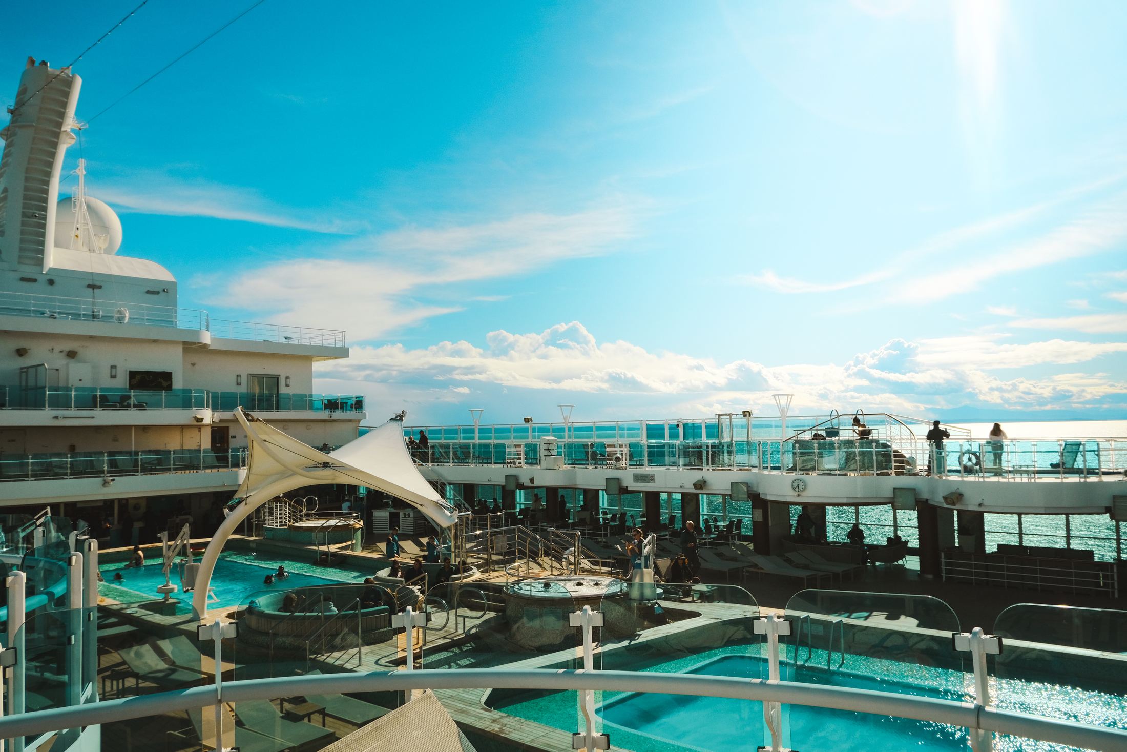 A sunny cruise ship pool deck at sea