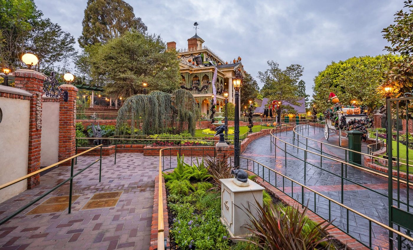Disneyland's white-columned Haunted Mansion dressed for the holidays